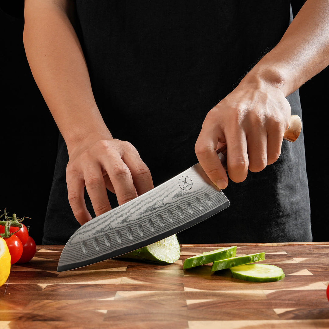 Damascus Santoku knife cutting vegetables – 67-layer steel hardened to 60-62 HRC