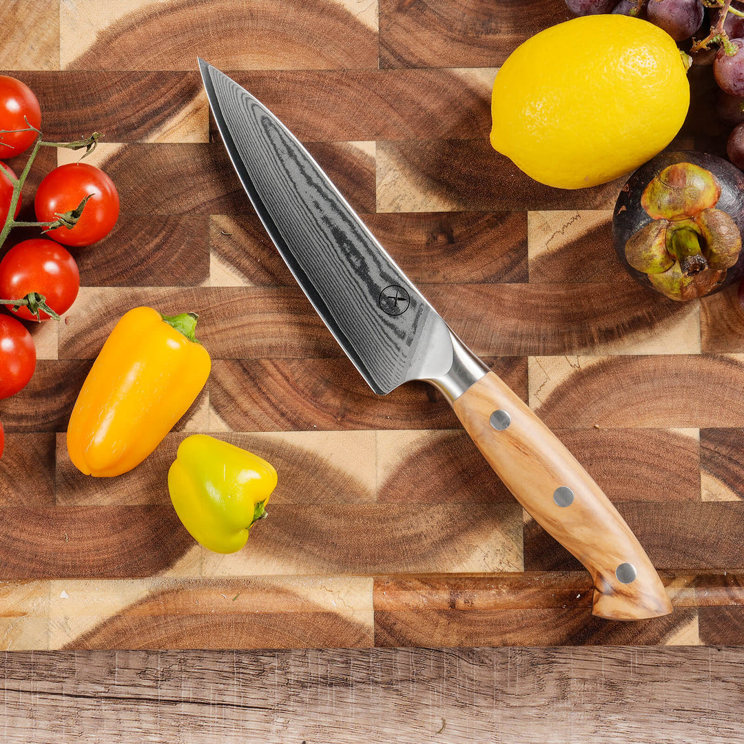 67-layer Damascus steel Utility knife with olive wood handle on walnut cutting board